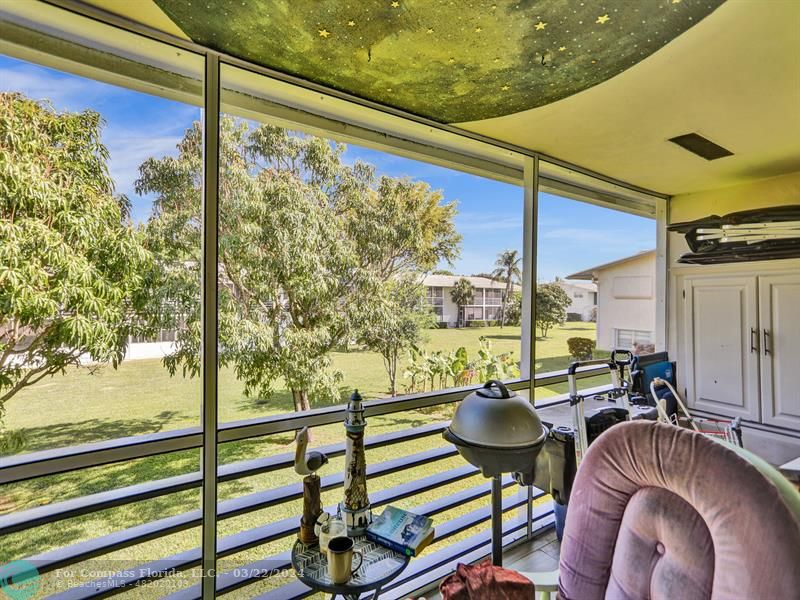 a balcony with chairs and a table