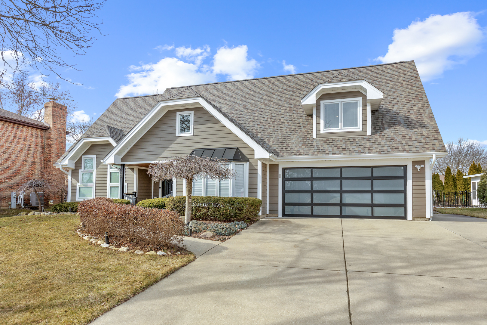 a front view of a house with a yard and garage