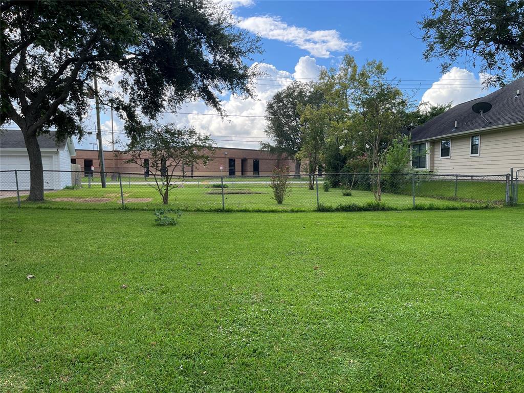 a view of a backyard with large trees