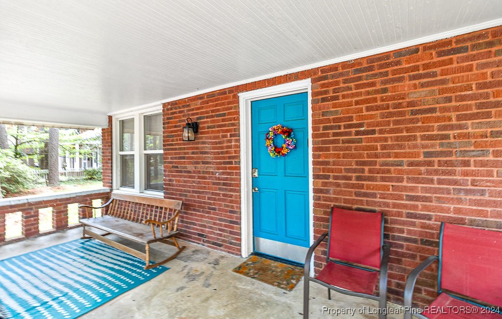 a balcony with chairs and wooden floor