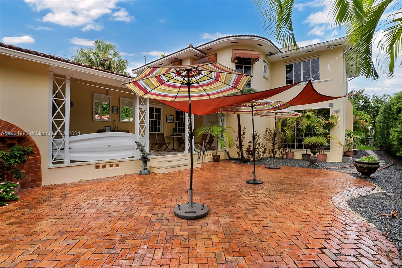 a view of a patio with a table and chairs under an umbrella