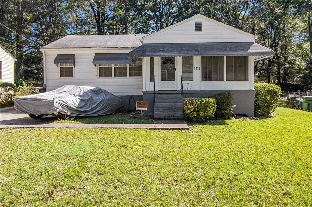 a front view of a house with a garden