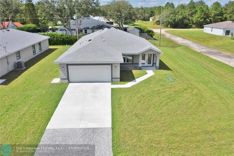 a aerial view of a house with a yard