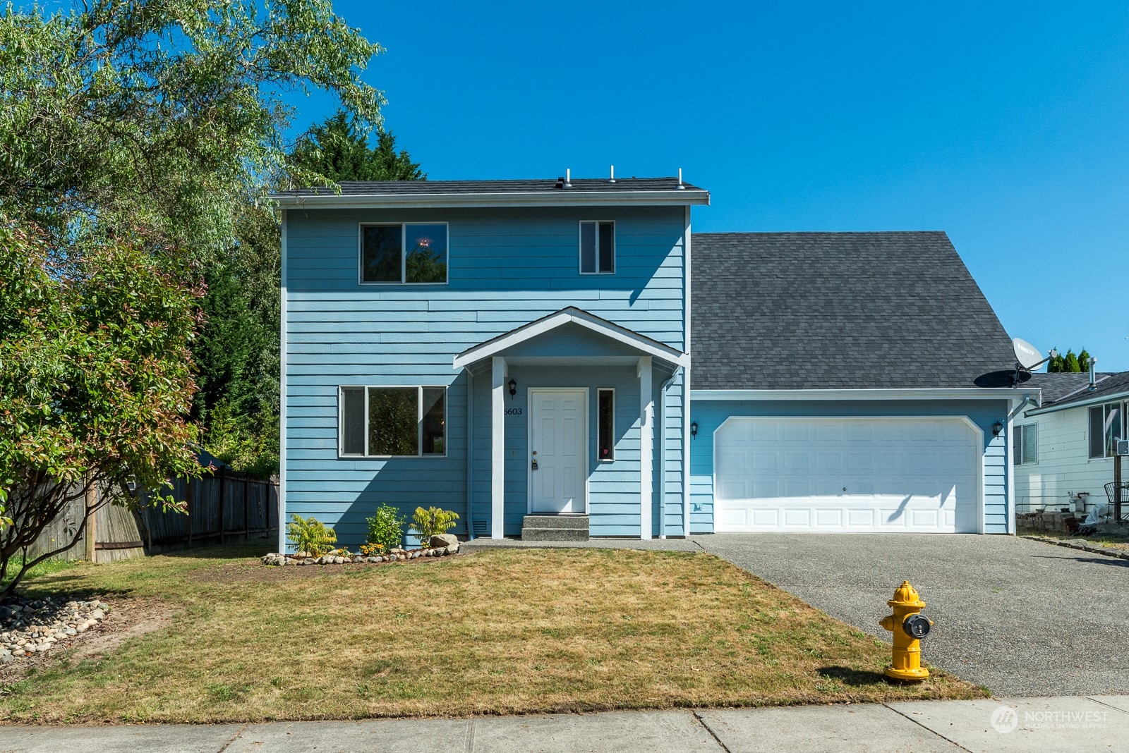 a front view of a house with a yard