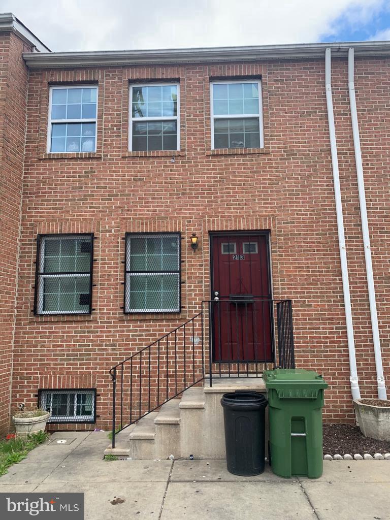 a brick building with a door and a chair