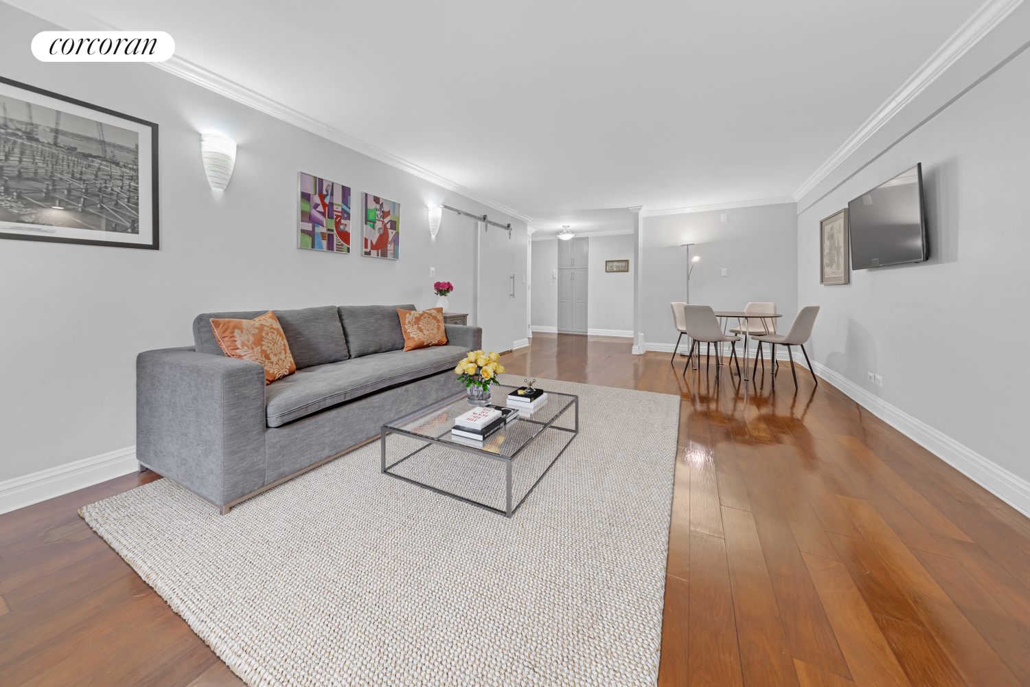 a living room with furniture wooden floor and a flat screen tv