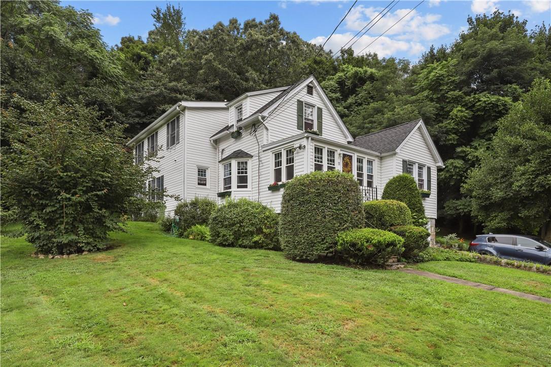 a front view of a house with a garden