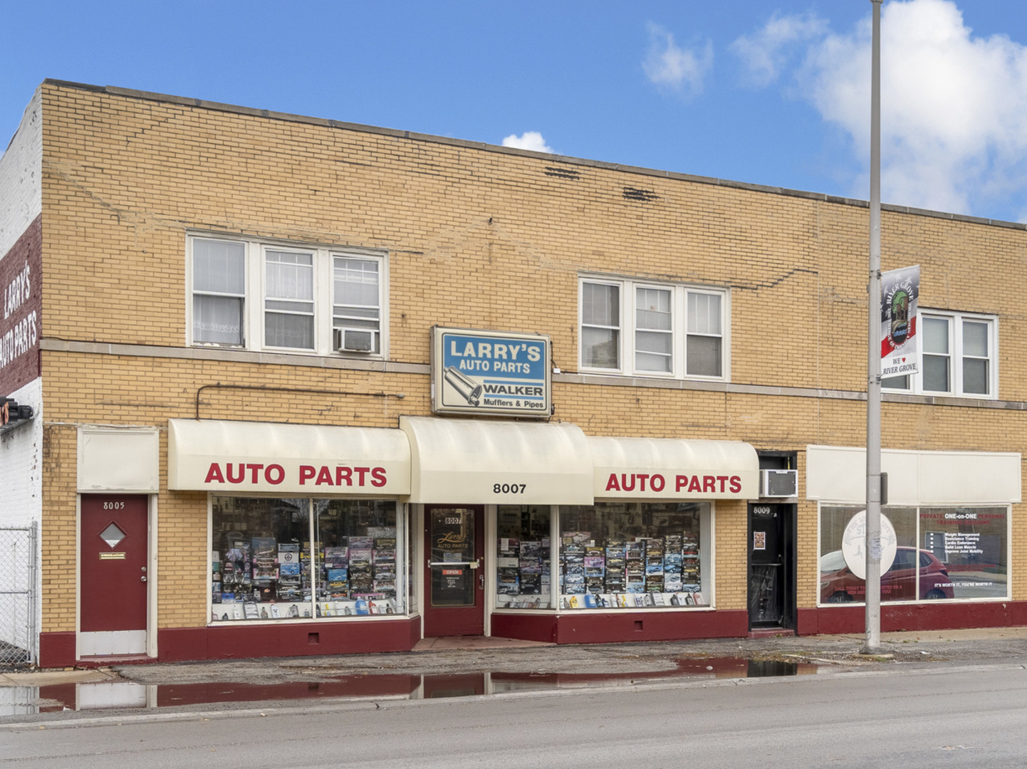 a front view of multi story building with retail shop and retail shops