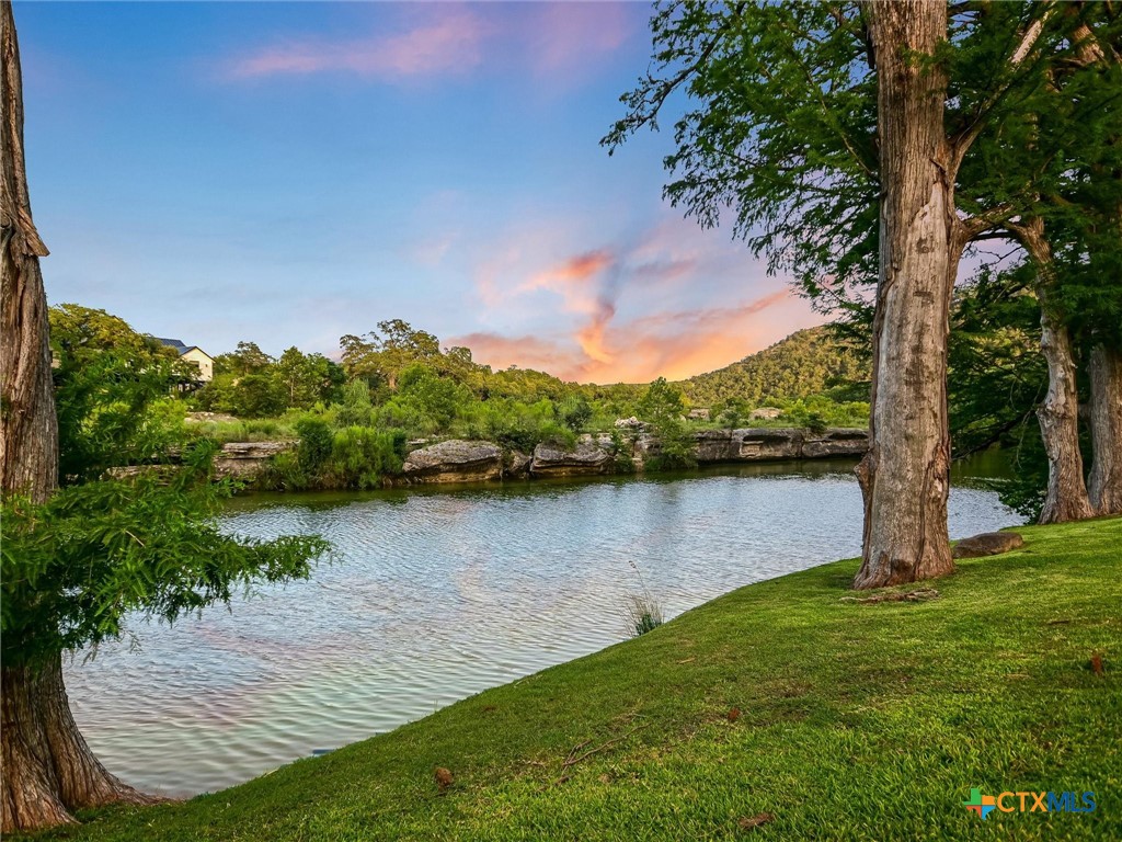 a view of a lake with houses in the back