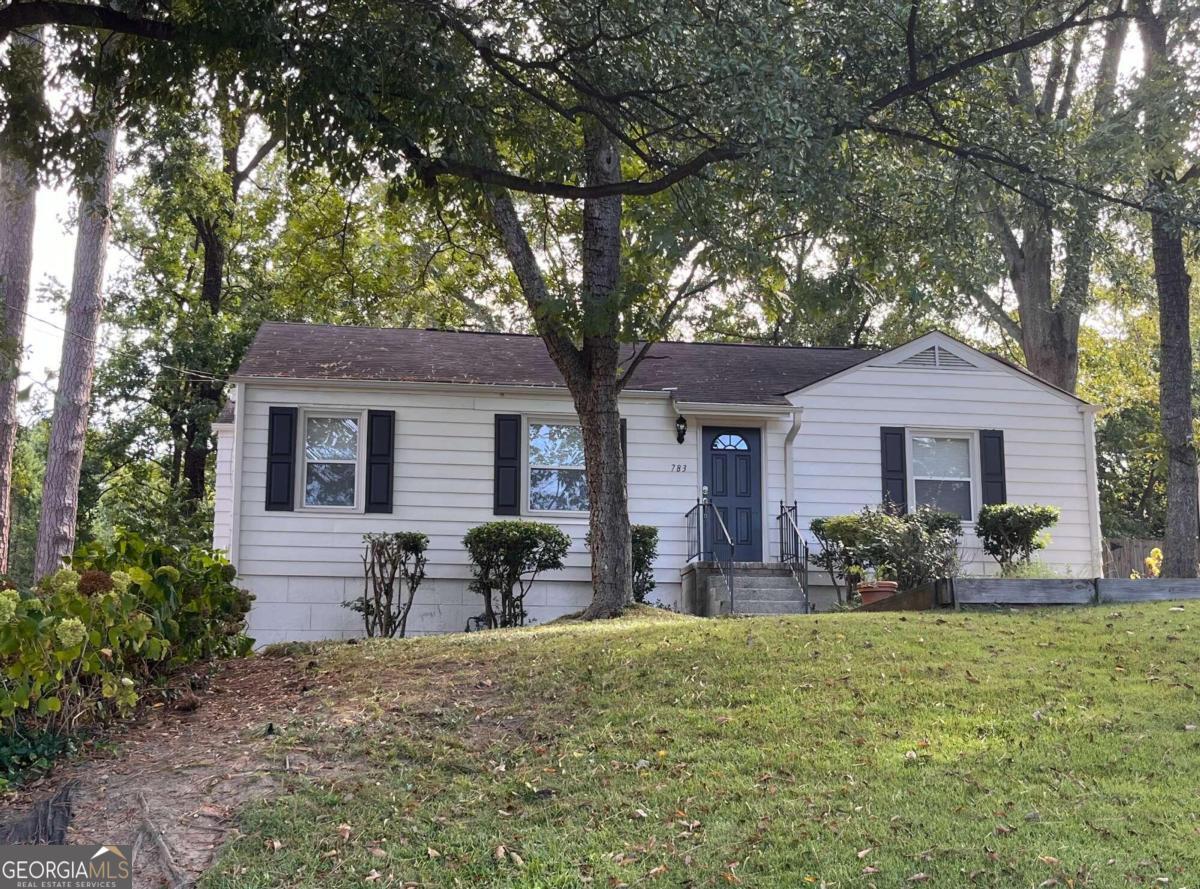 a front view of a house with garden