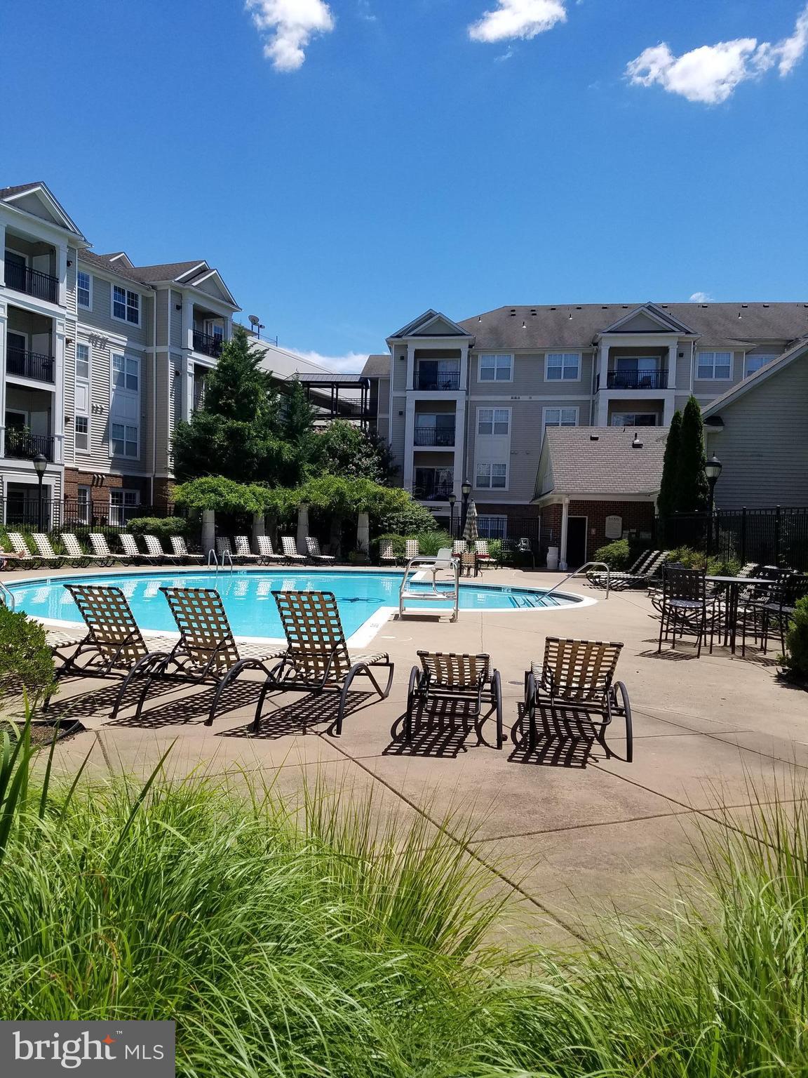 a swimming pool with outdoor seating and yard