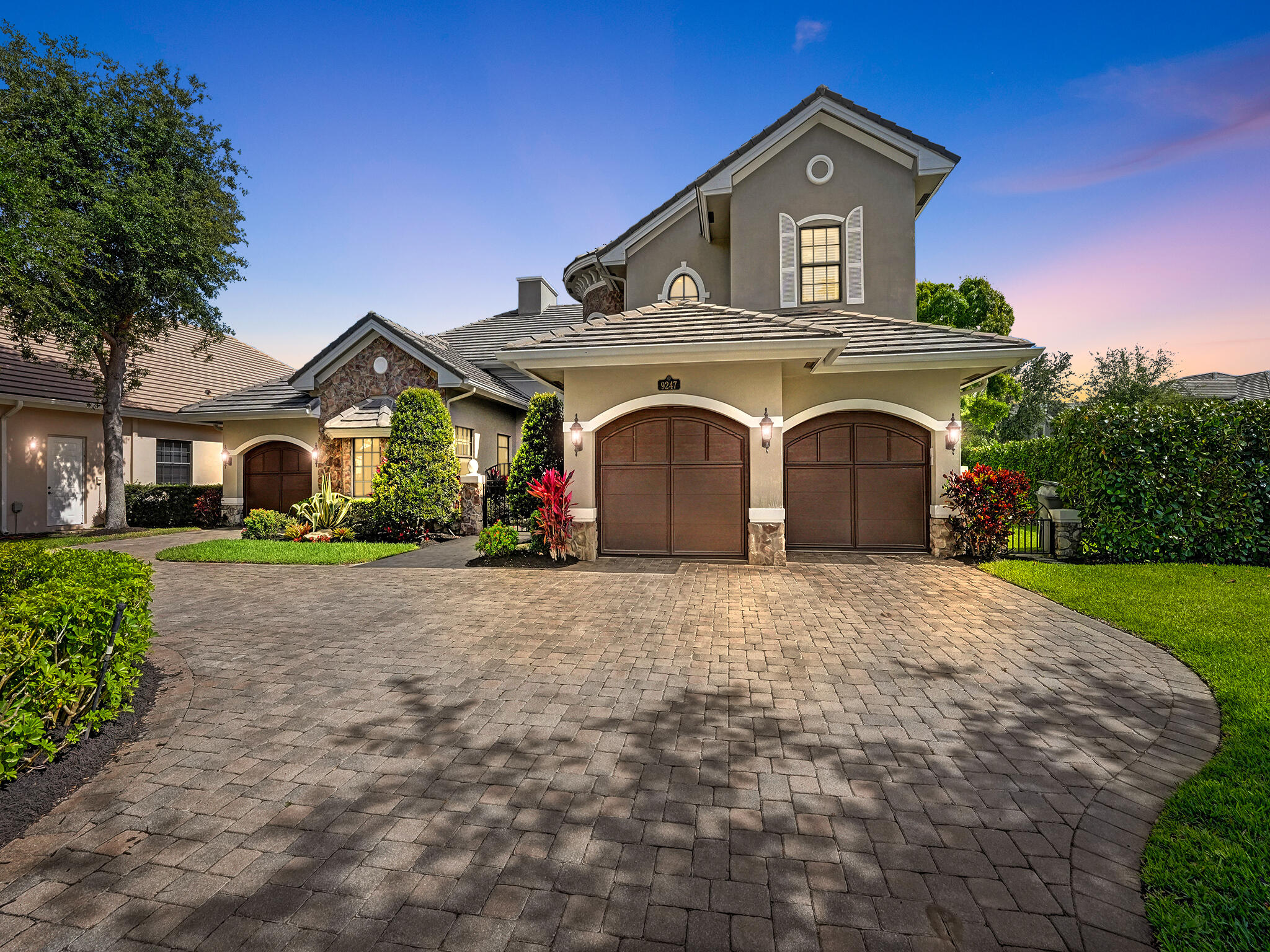 a front view of a house with a garden and plants