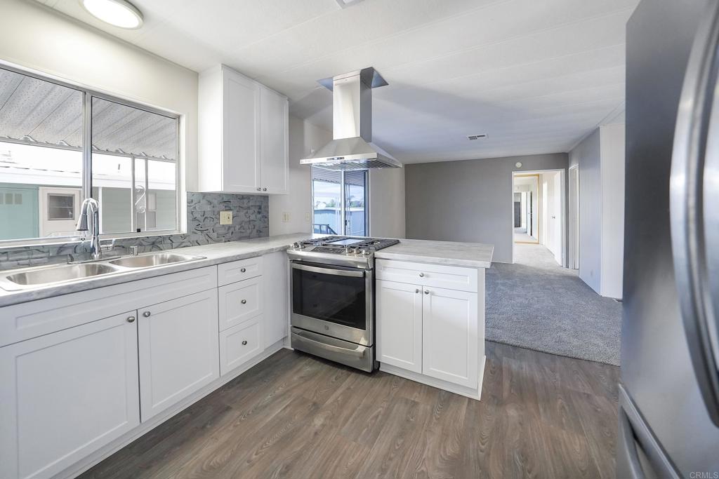 a kitchen with a stove a sink and a refrigerator