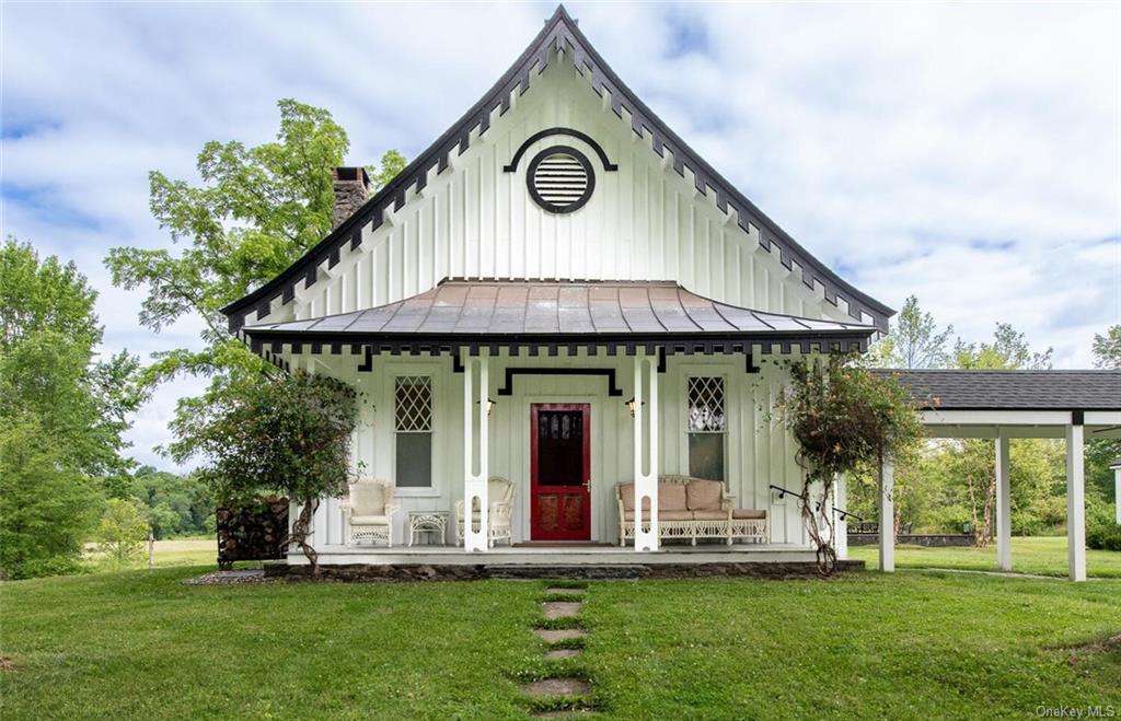 View of front of house featuring covered porch and a front lawn