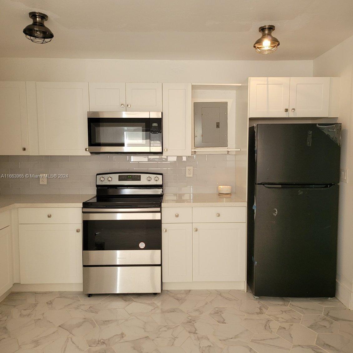 a kitchen with a refrigerator stove and microwave