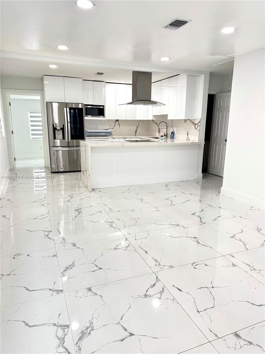 a kitchen with stainless steel appliances cabinets a sink and a counter top space