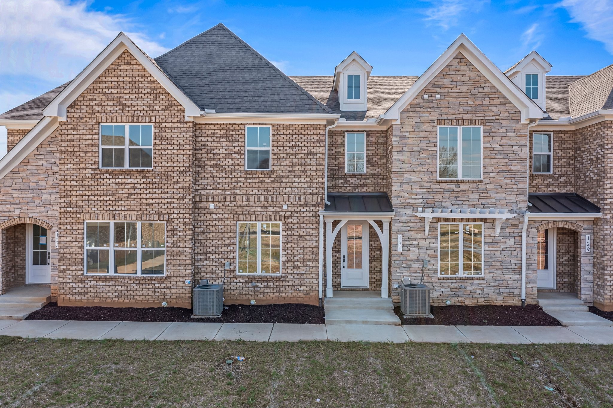 a front view of a house with a yard