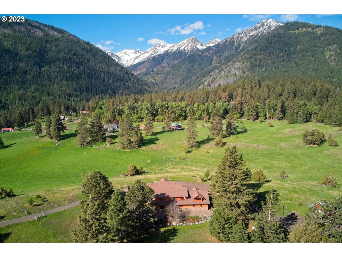 a view of a lush green hillside and houses