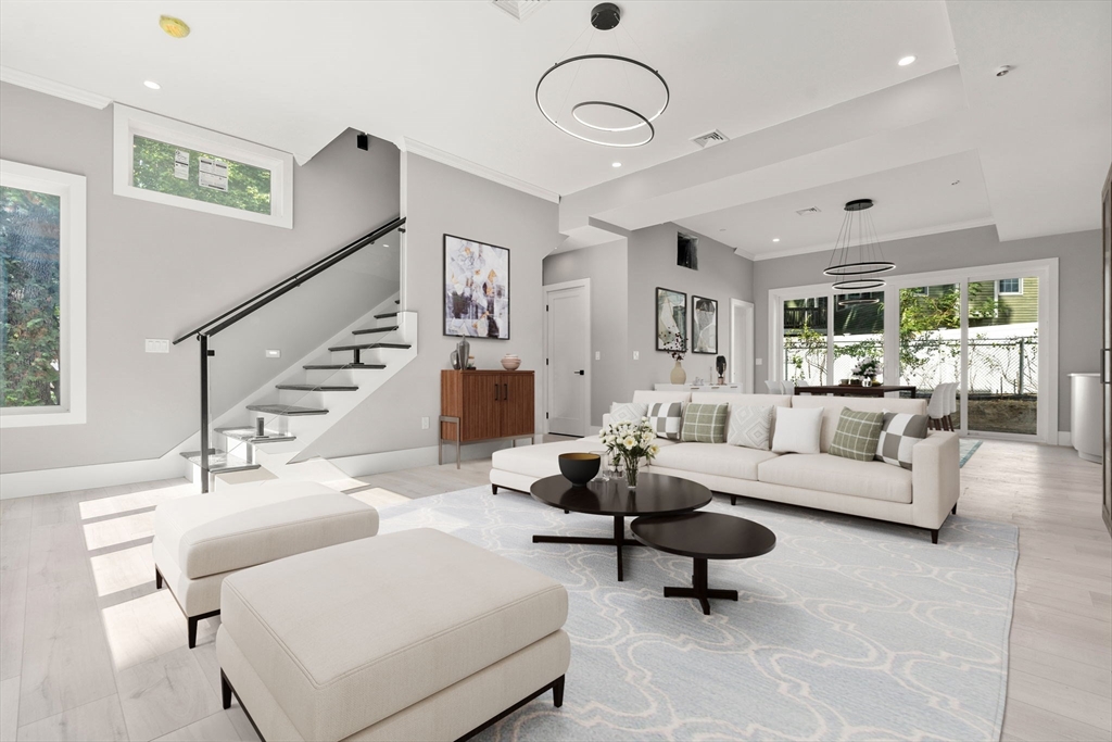 a living room with furniture ceiling fan and a rug