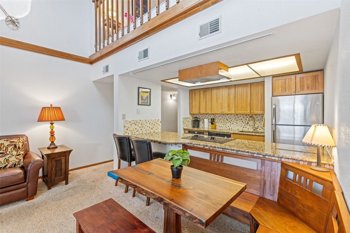 Dining room featuring sink and a towering ceiling