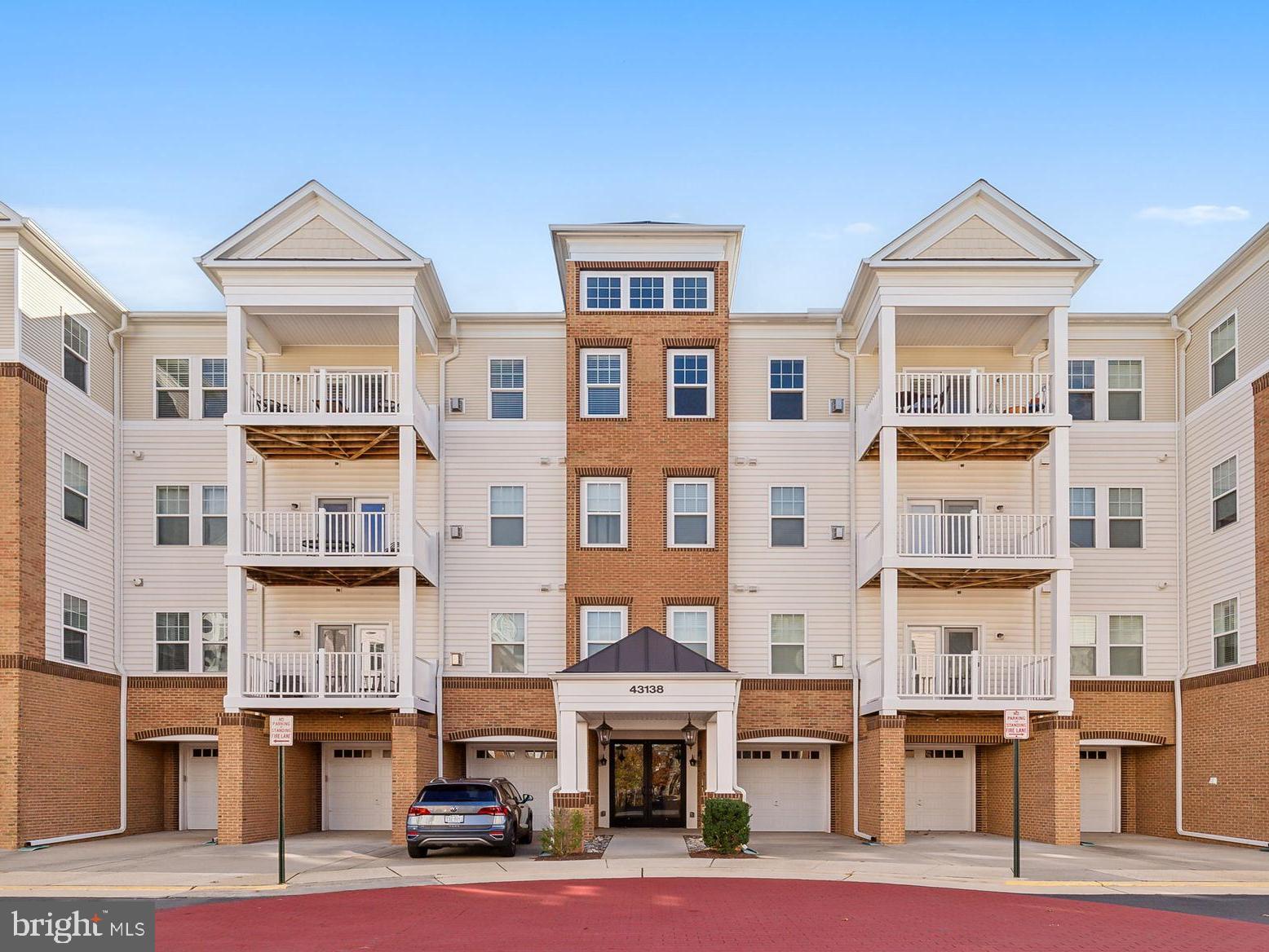 a front view of a residential apartment building with a yard