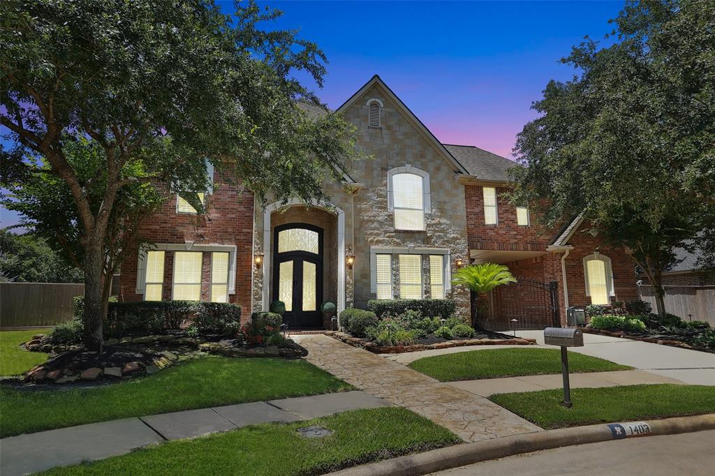Brick and stone exterior with pull through gated motor court. LimeStone accents the windows. Sidewalks and mature trees