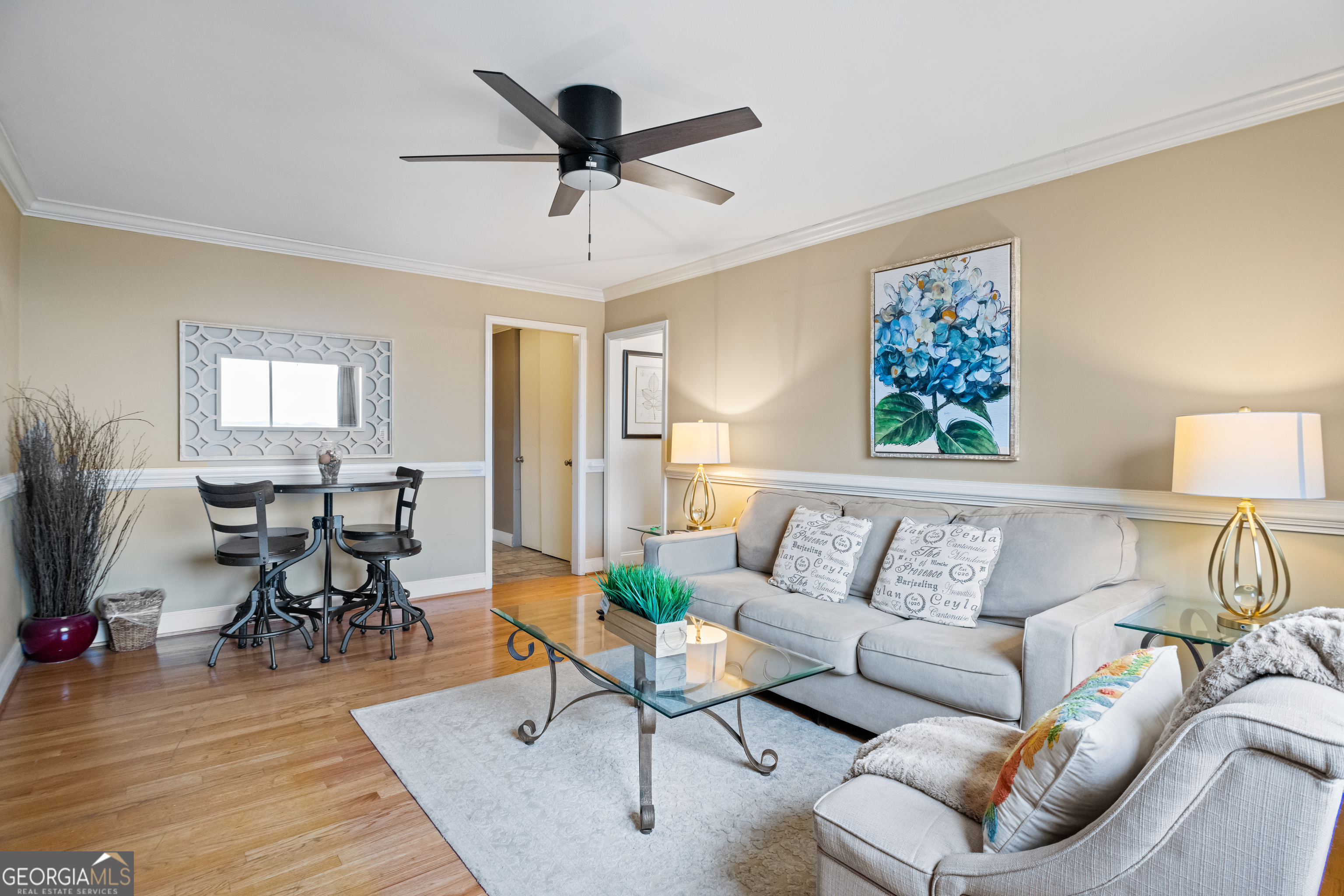 a living room with furniture and a ceiling fan