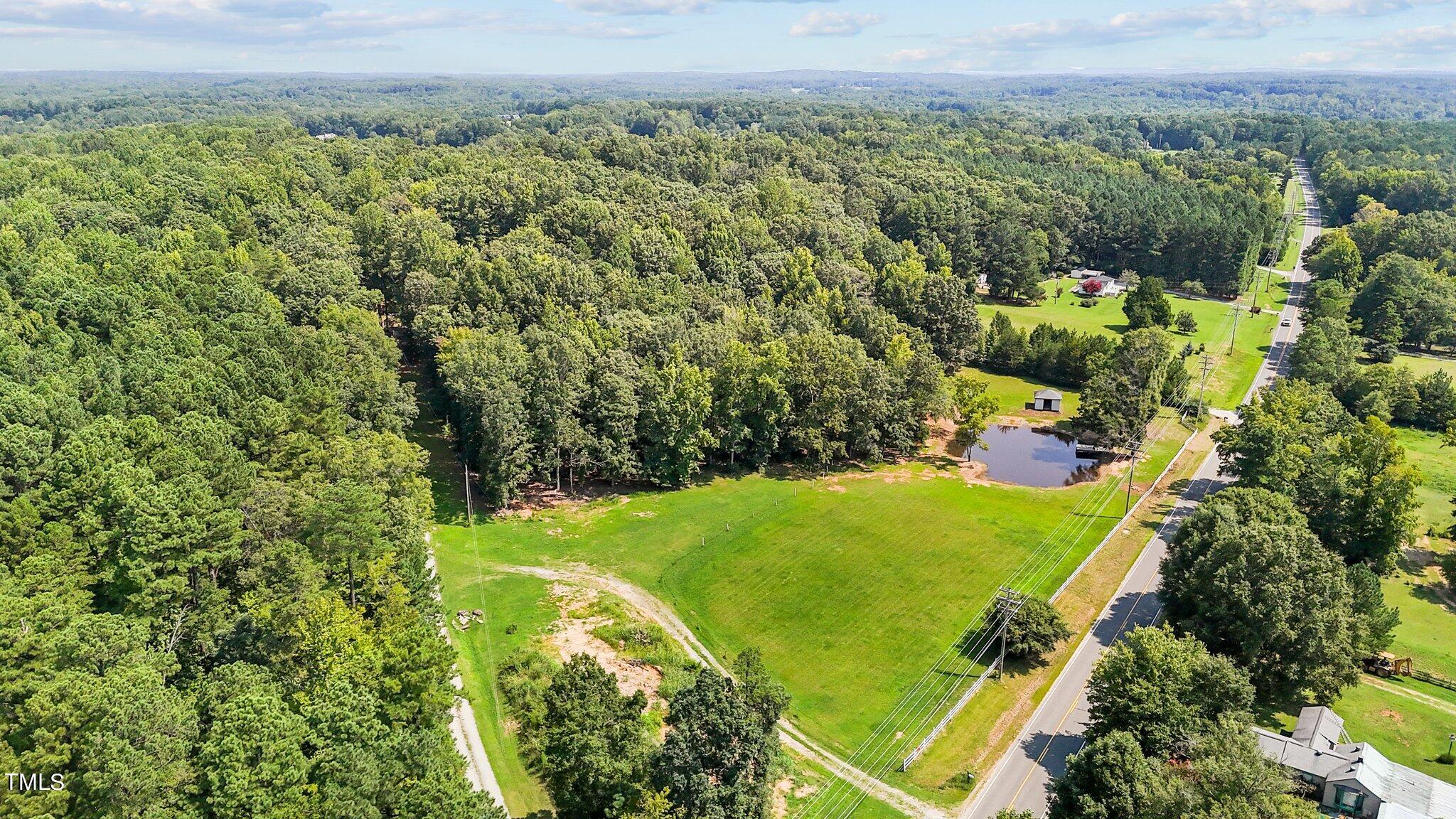 an aerial view of a residential houses with city view