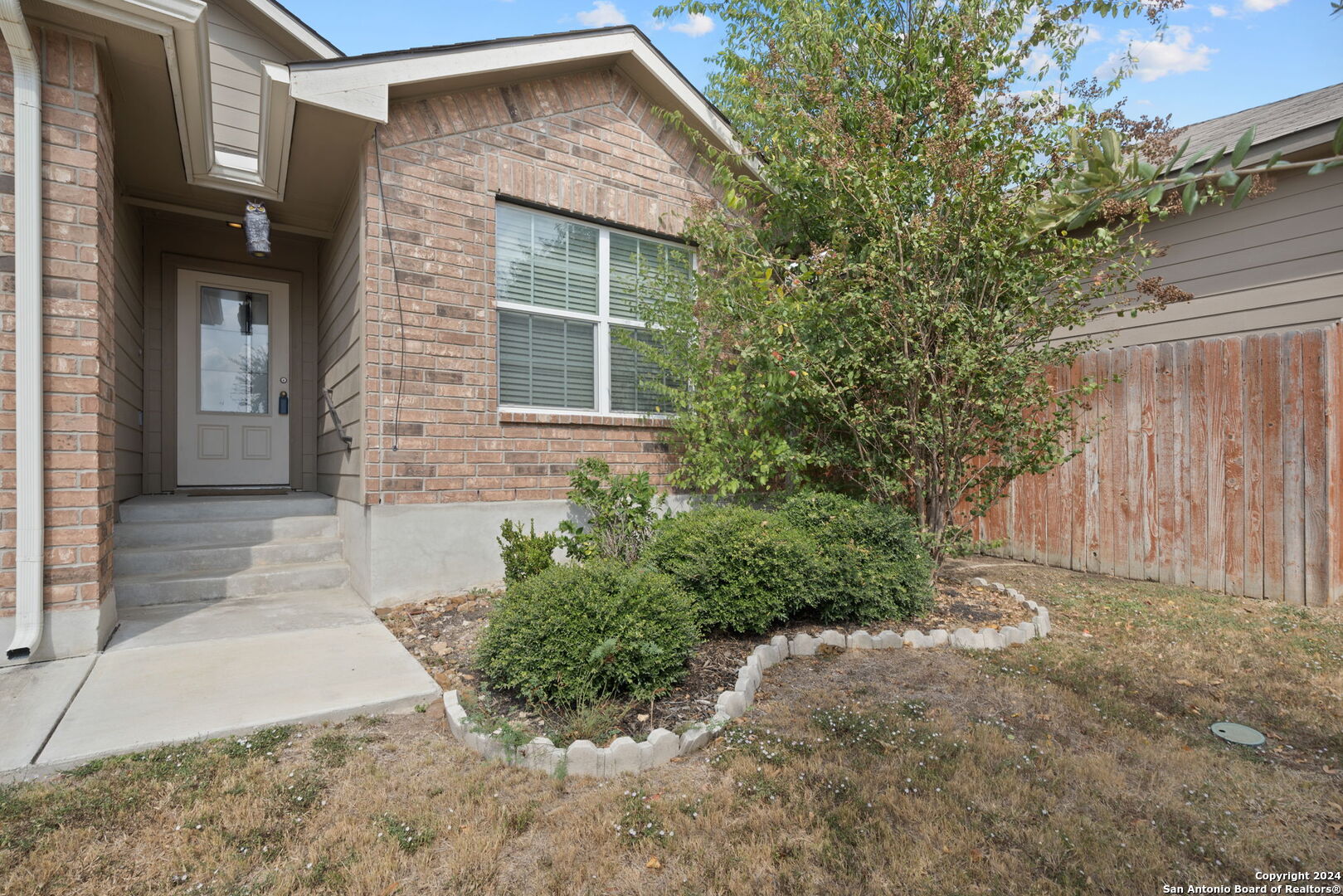 a front view of a house with garden