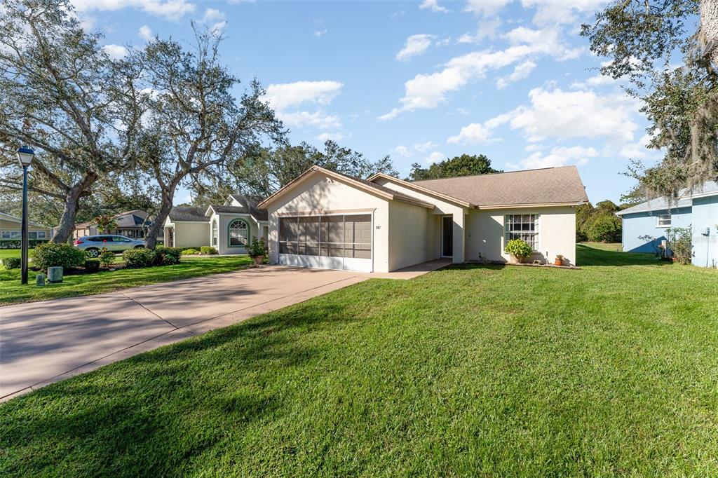 a front view of a house with yard and green space