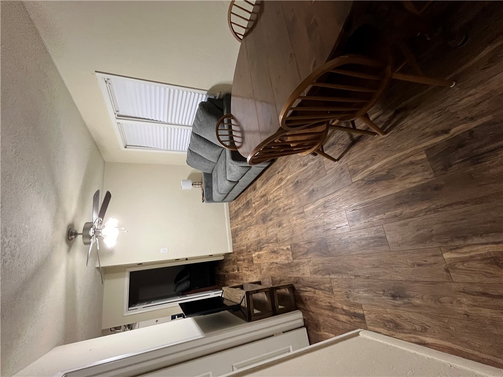 a view of a livingroom with furniture wooden floor and staircase