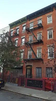 a front view of a residential apartment building with a yard