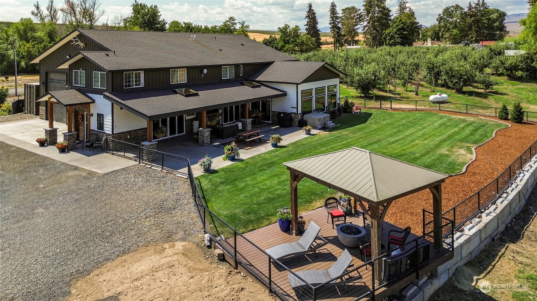 an aerial view of a house with swimming pool and garden