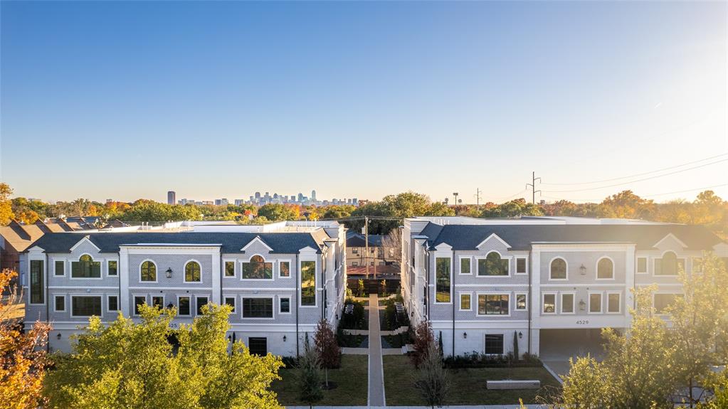 a front view of a residential apartment building with a yard