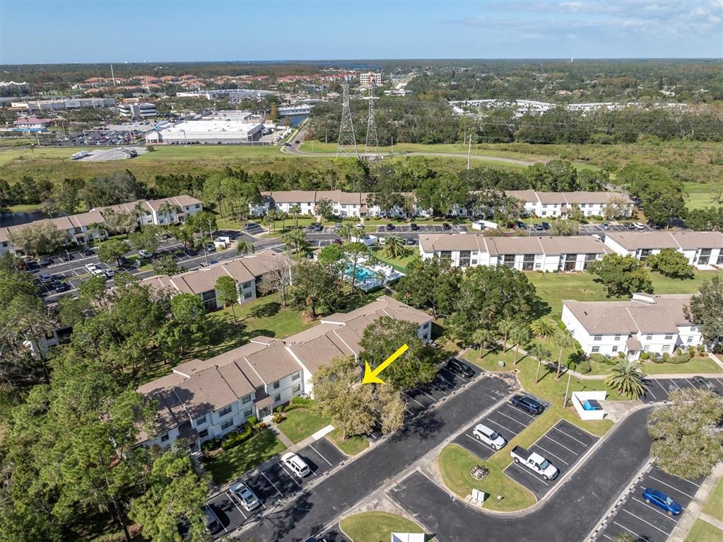 an aerial view of residential houses with outdoor space and swimming pool