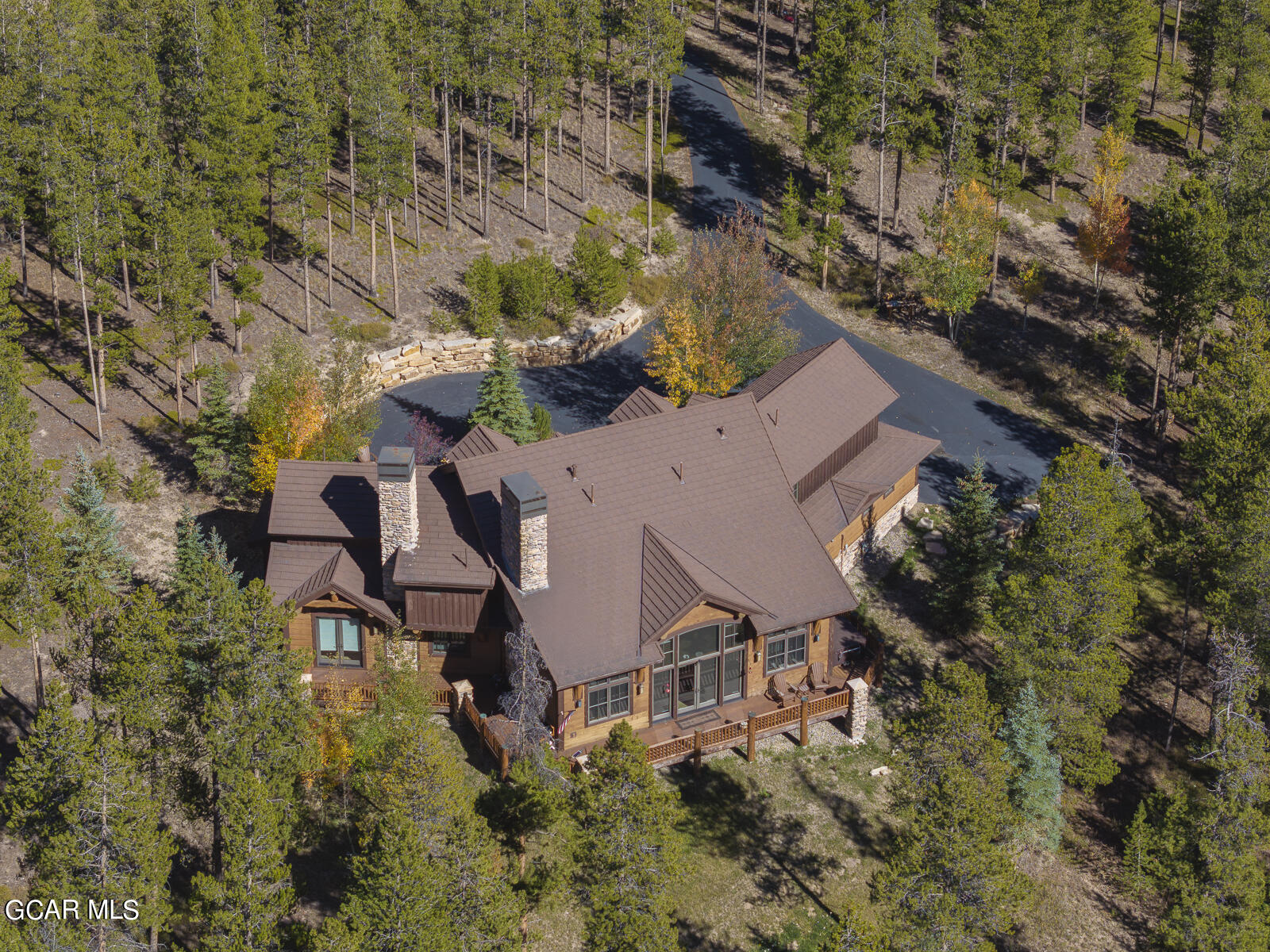 an aerial view of a house with garden space and street view