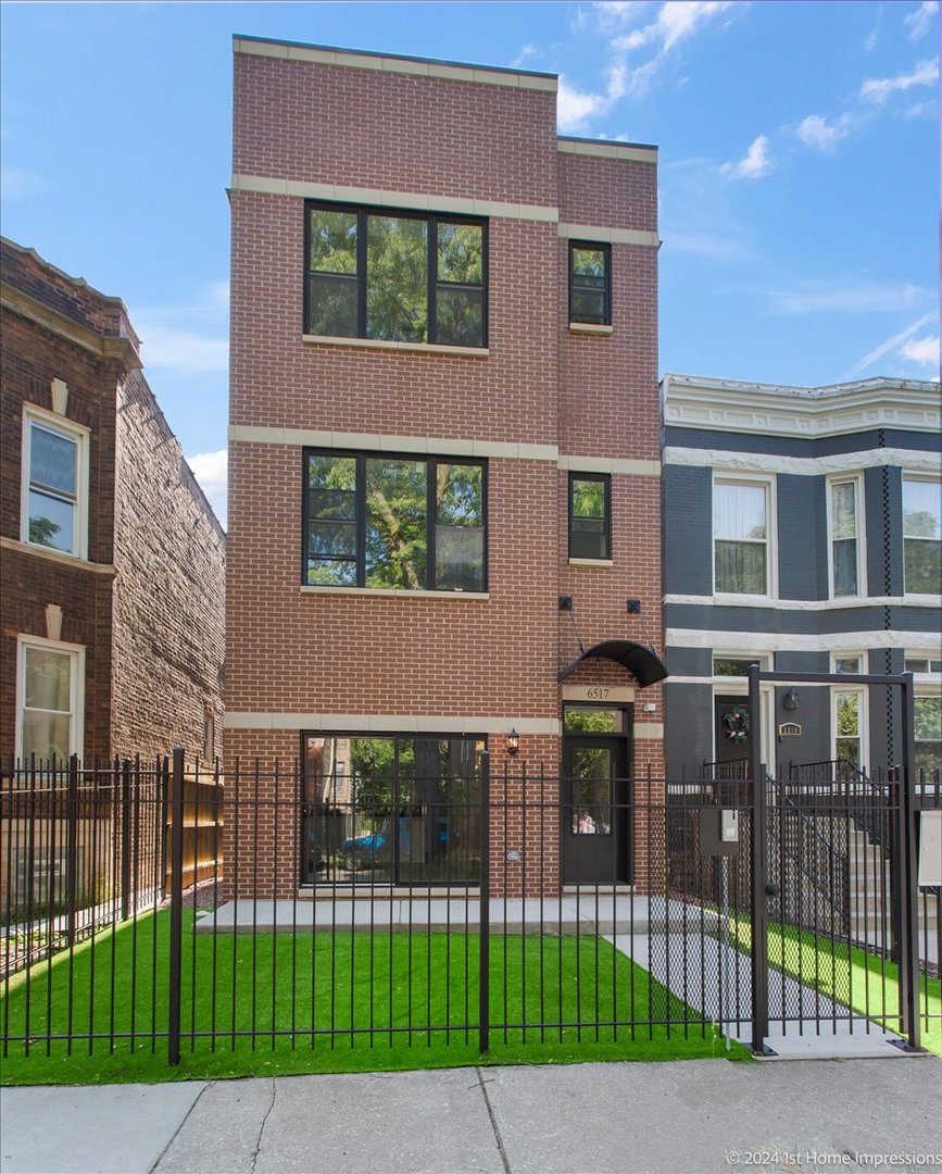 a view of a brick building next to a yard