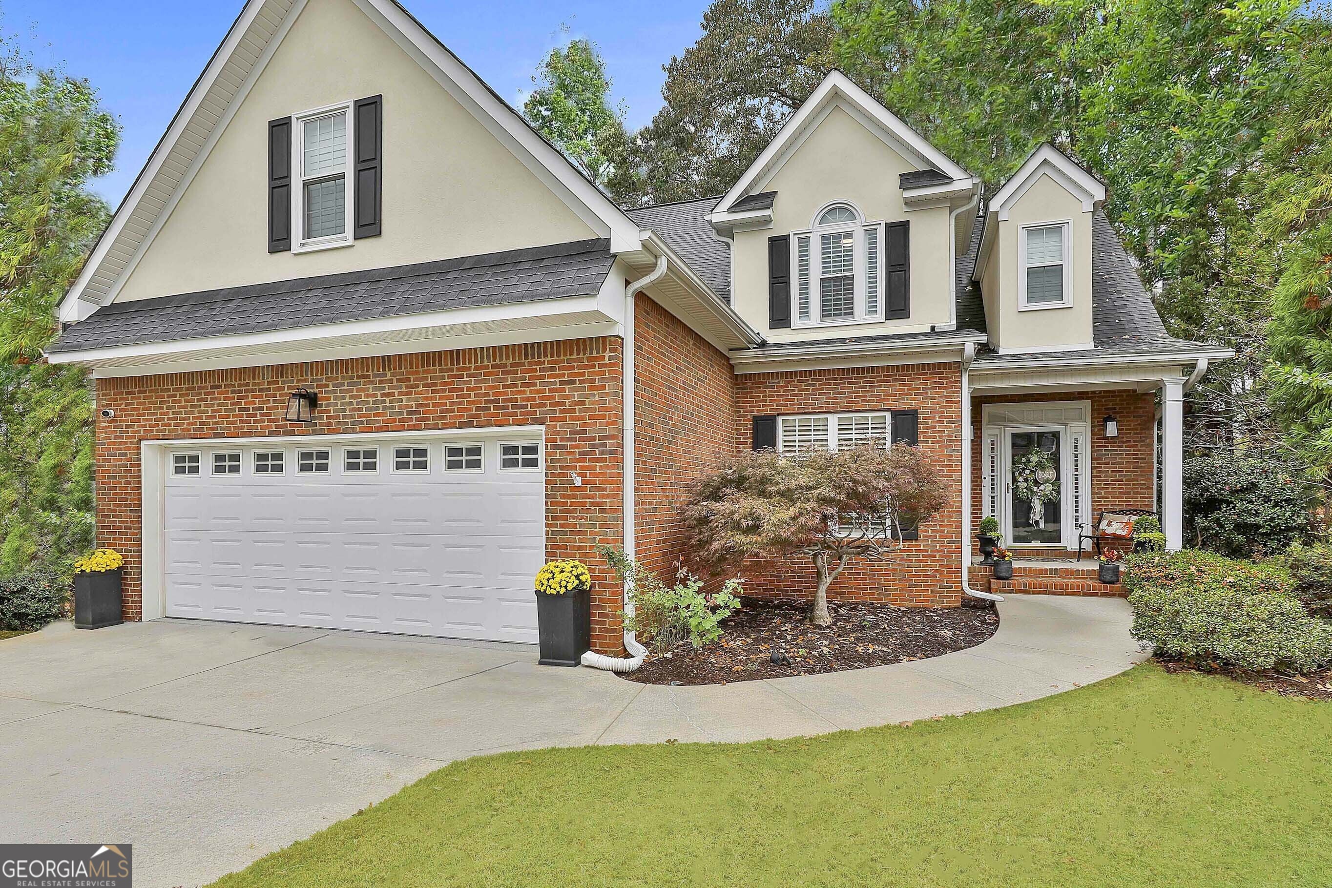 a front view of a house with a yard and garage