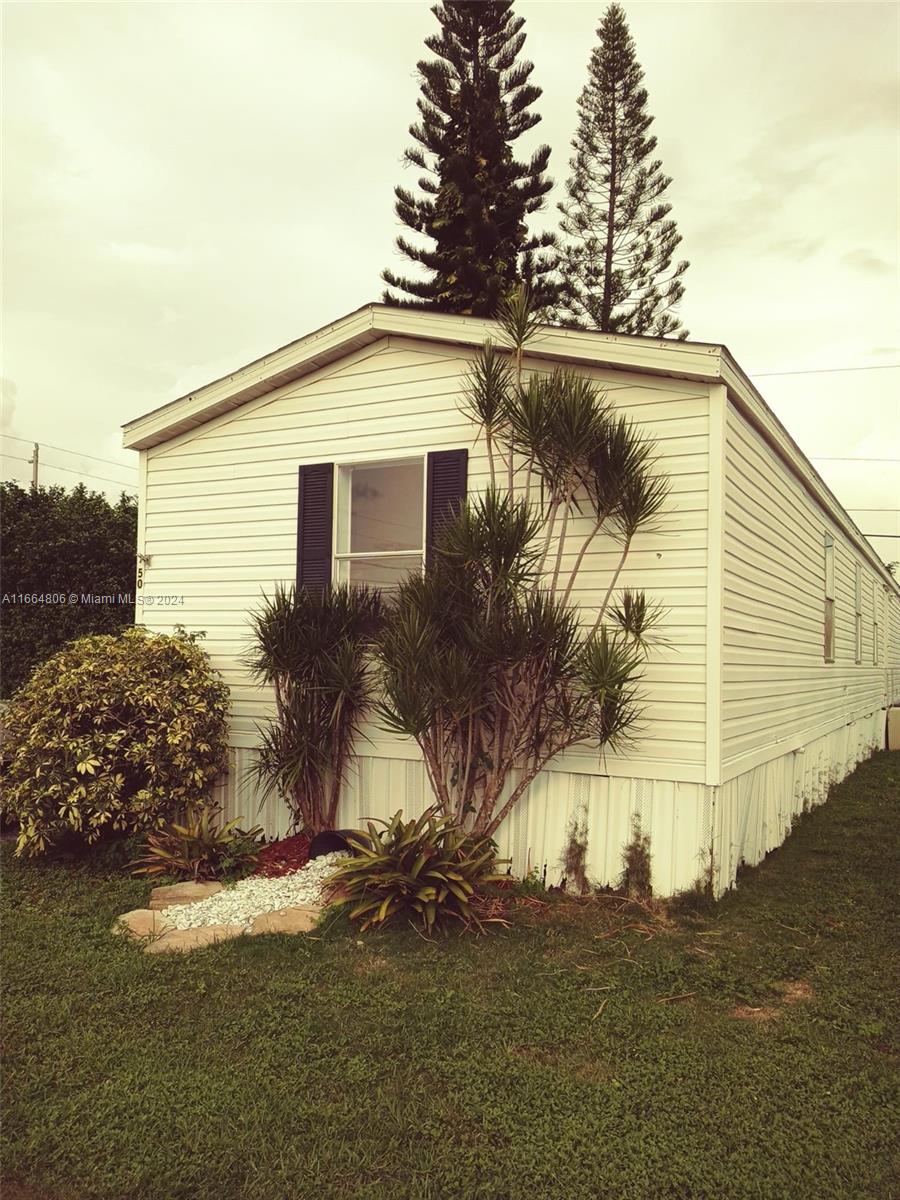 a house that has a tree in front of it