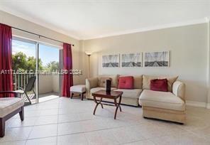 a living room with furniture and a floor to ceiling window