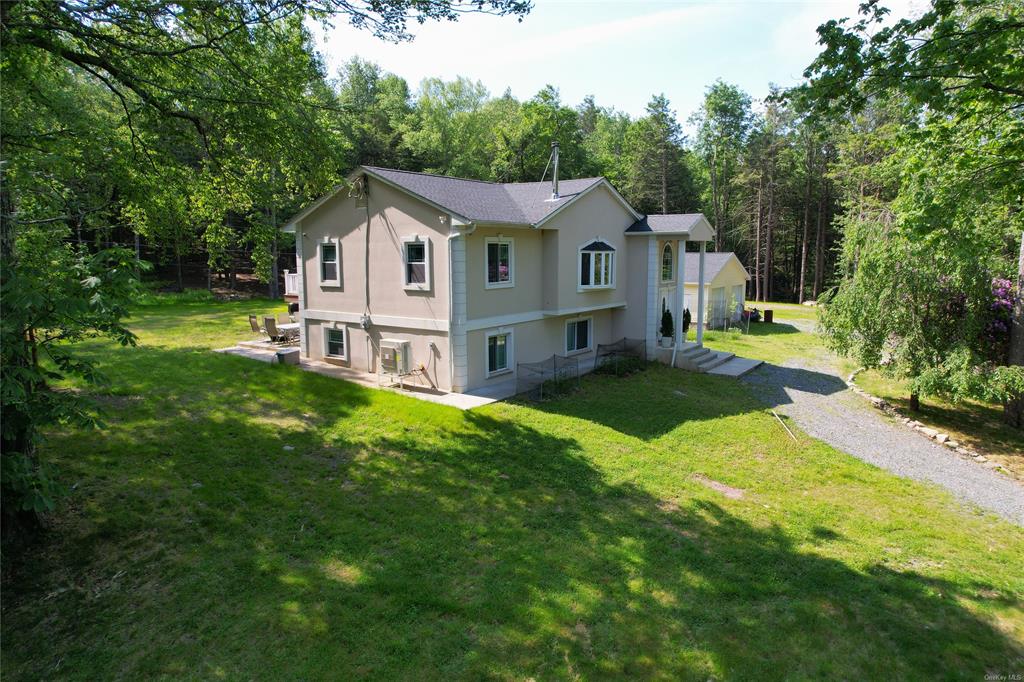 a aerial view of a house with a yard table and chairs