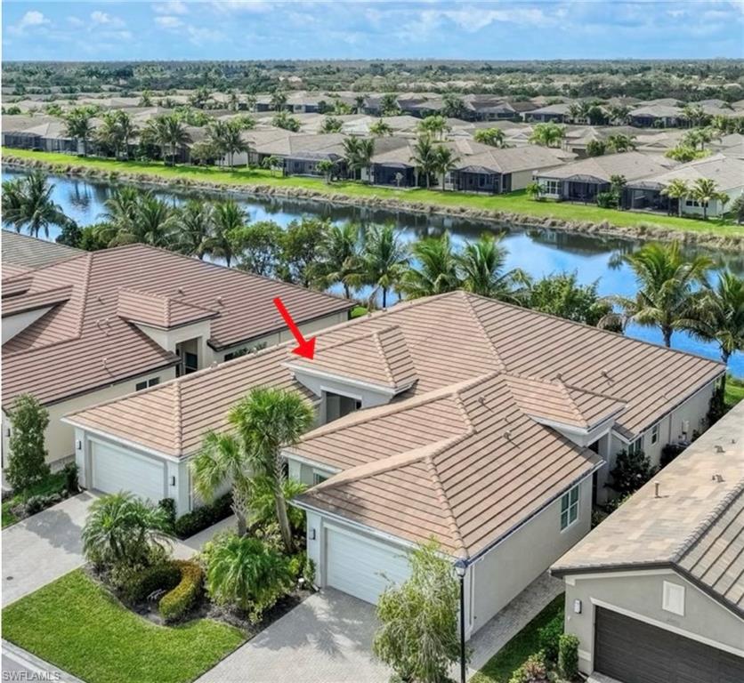 an aerial view of a house with a yard