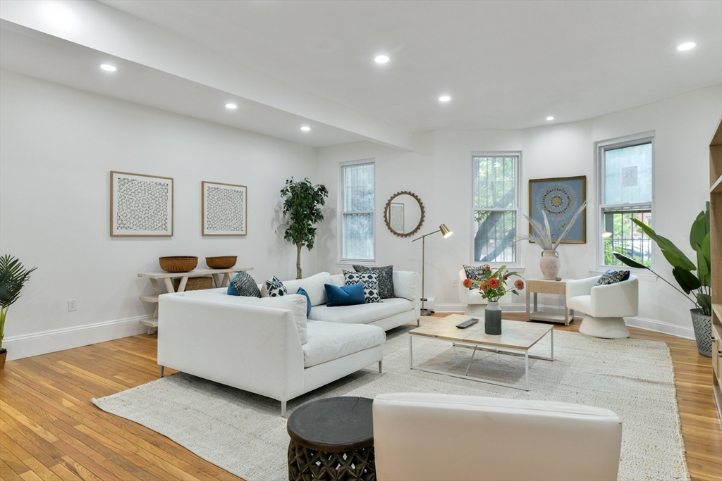 a living room with furniture and wooden floor