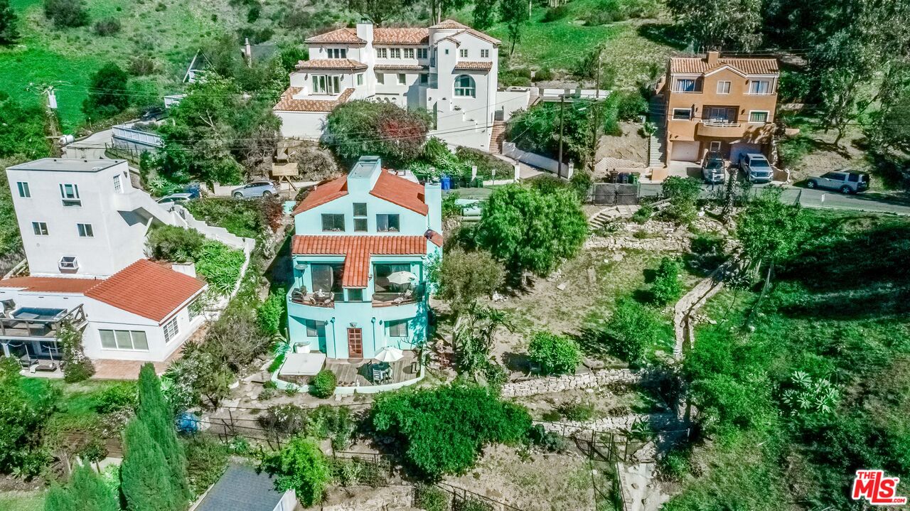 an aerial view of multiple houses with yard