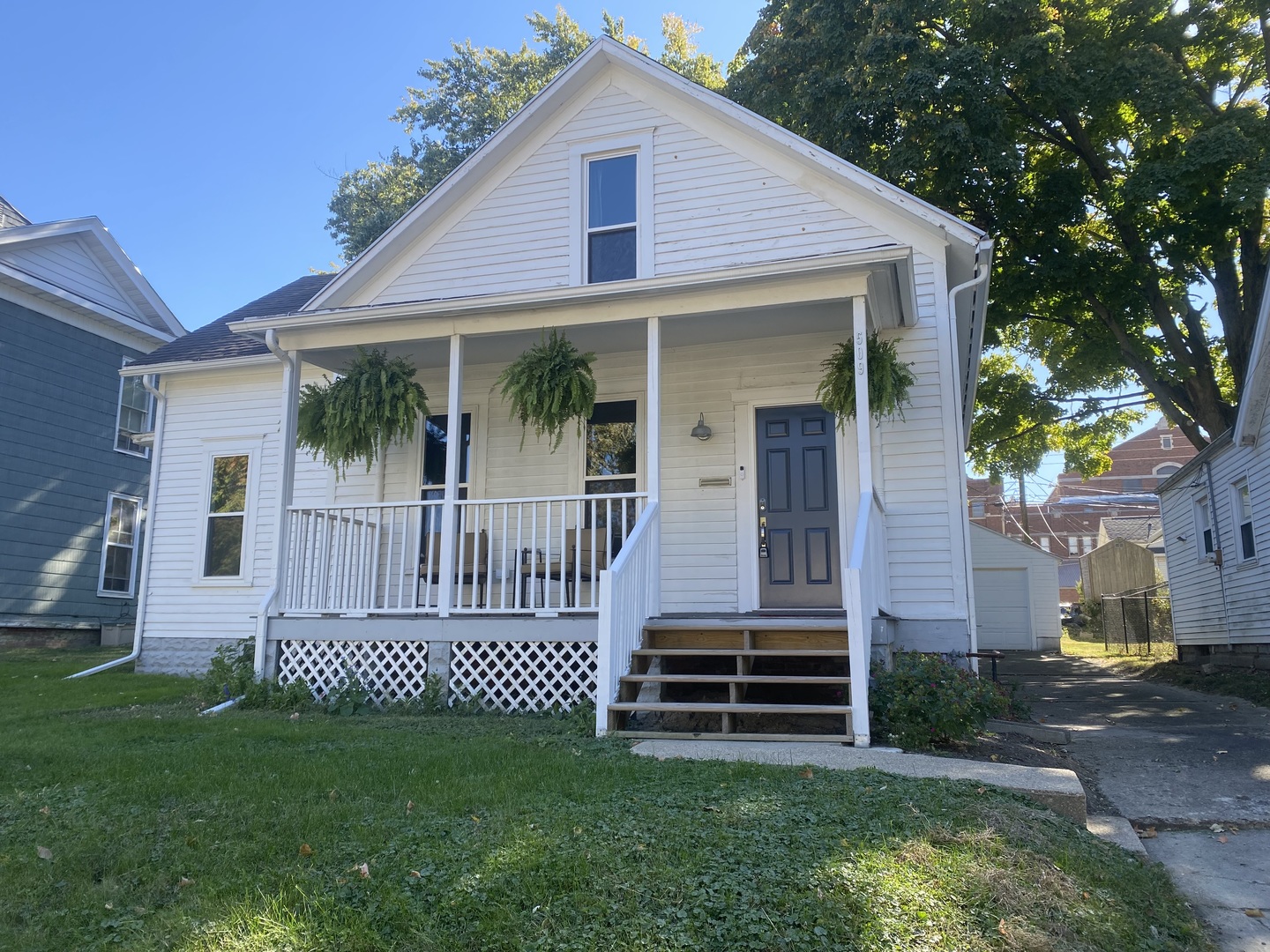 a front view of a house with a garden