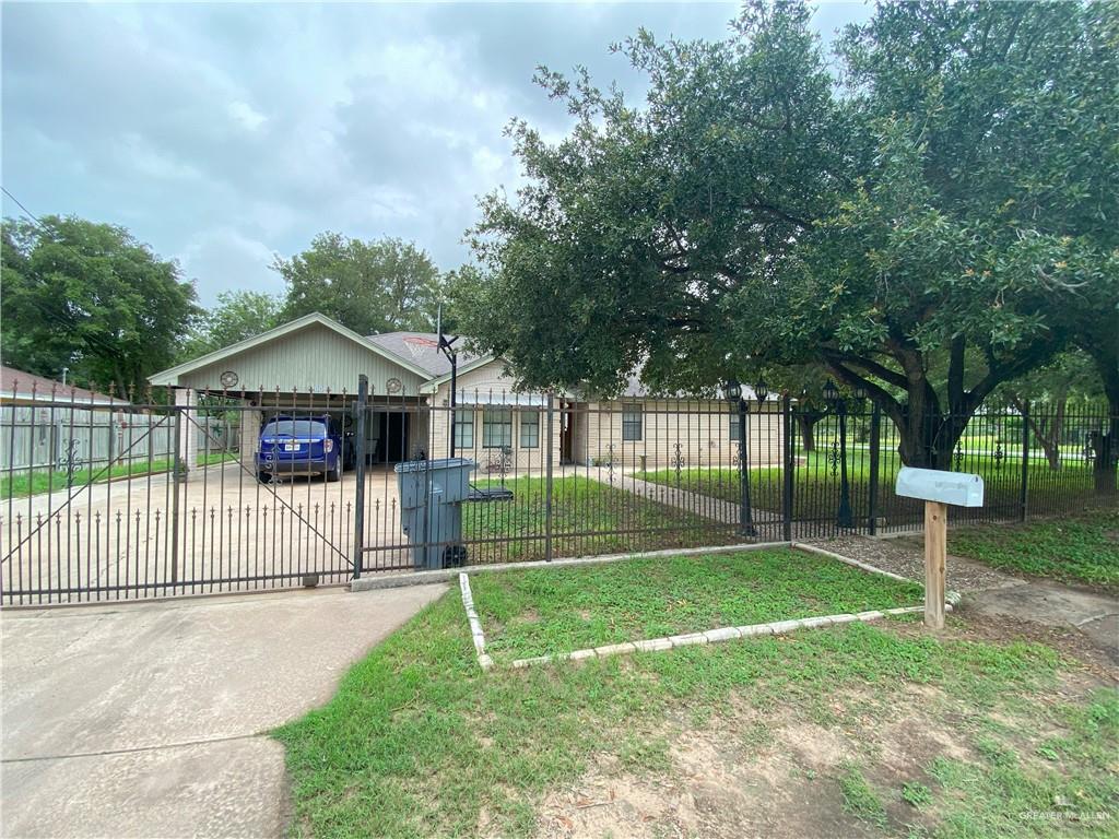 a view of a house with a yard and sitting area