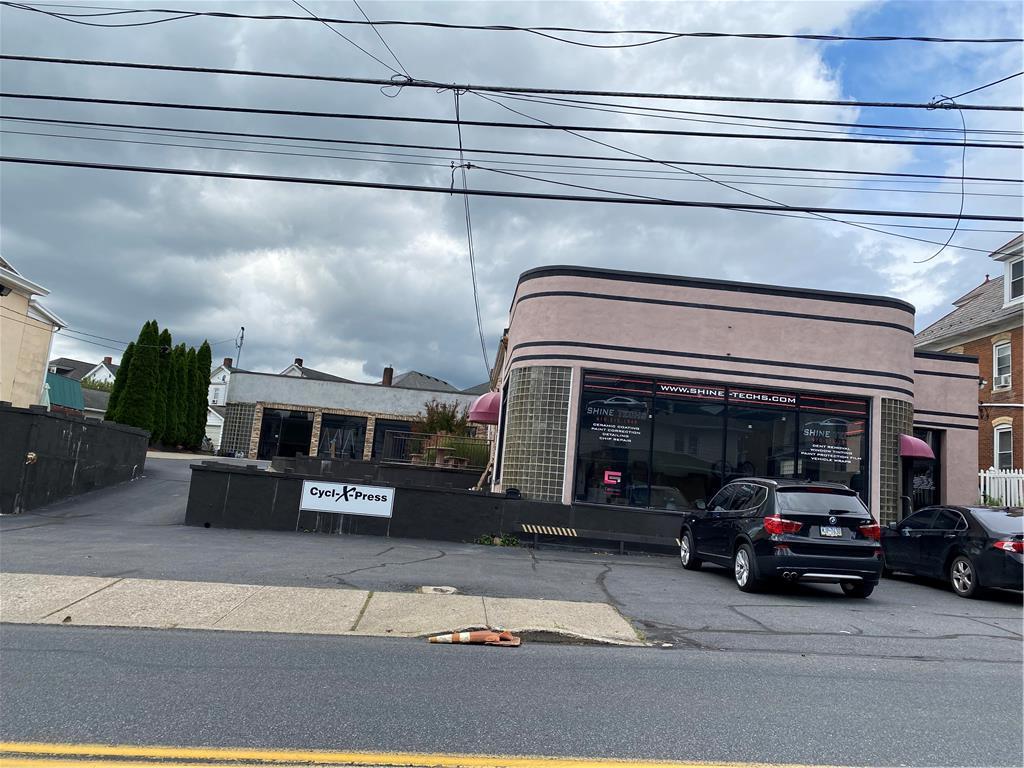 a view of a cars park in front of a building