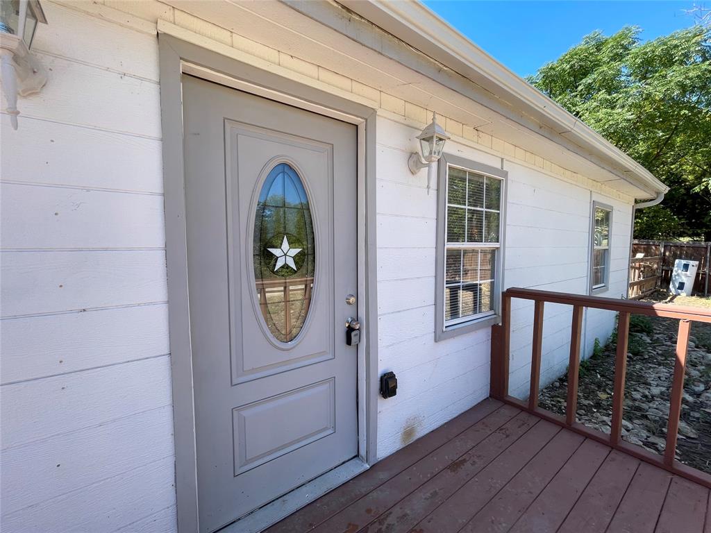 an entryway view with wooden floor and windows