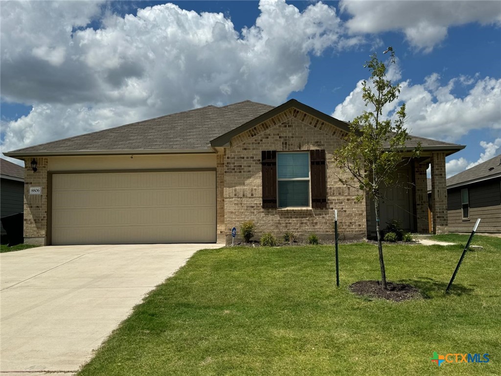 a front view of a house with a yard and garage