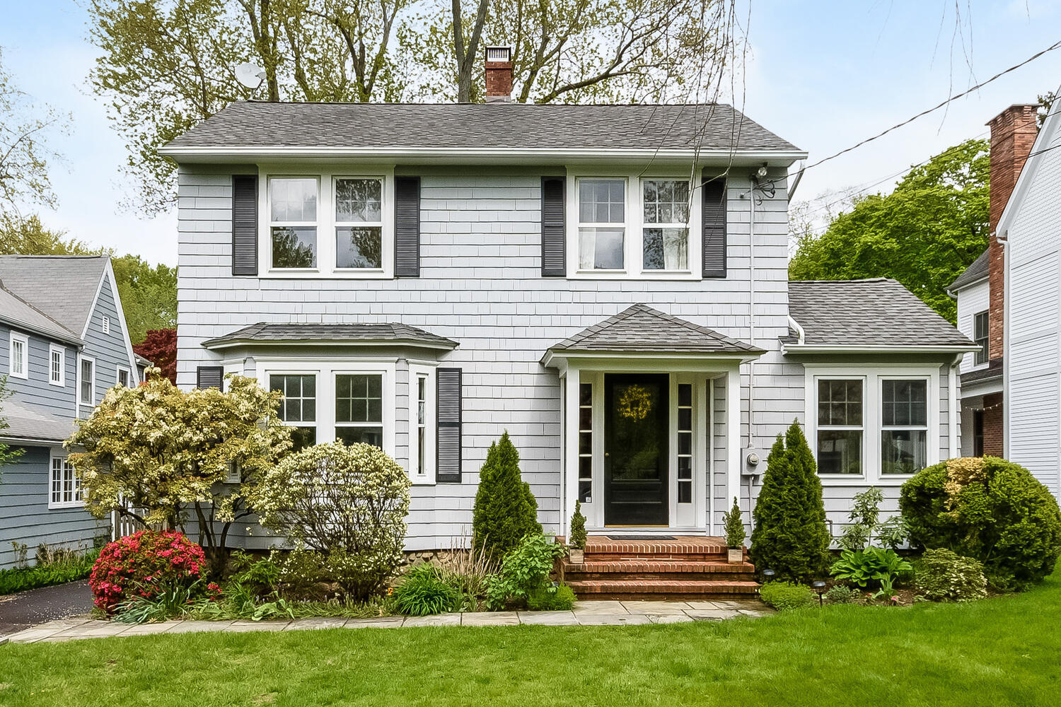 a front view of a house with garden